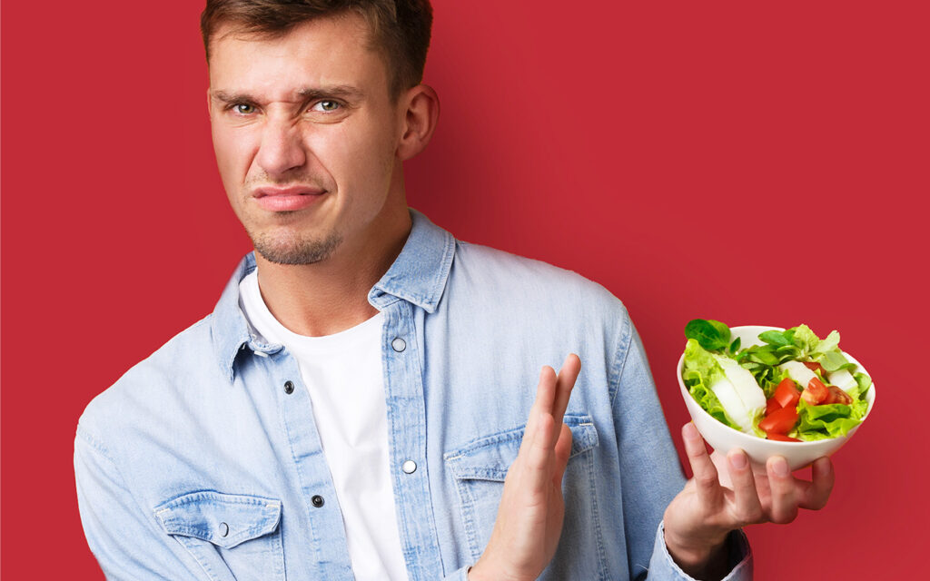 A photo of a guy who hates vegetables.