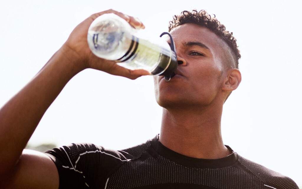 Photo of a guy drinking water.