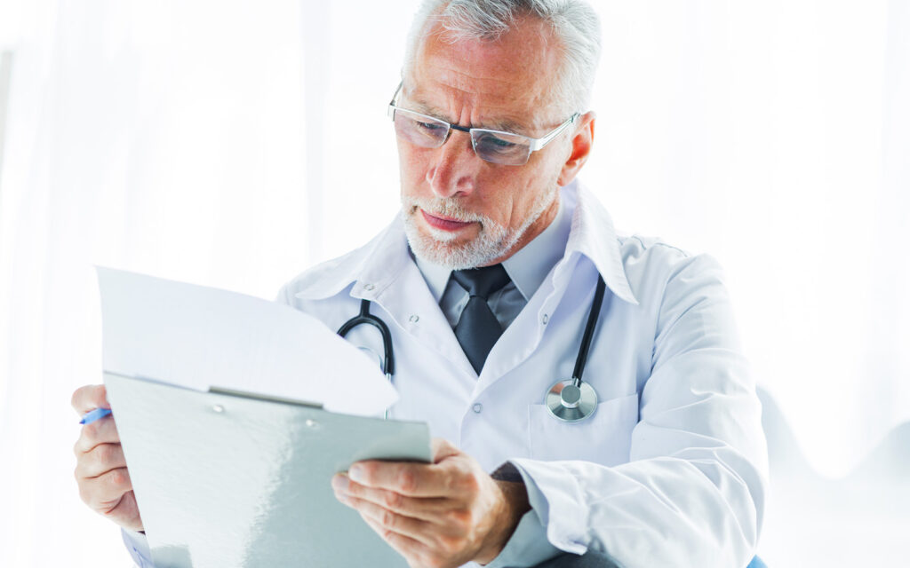 Image of a doctor reviewing some papers.