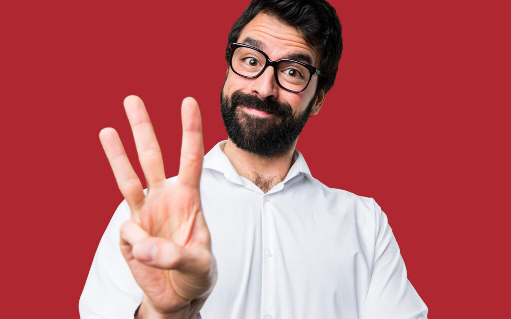 Photo of a goofy guy showing three fingers.