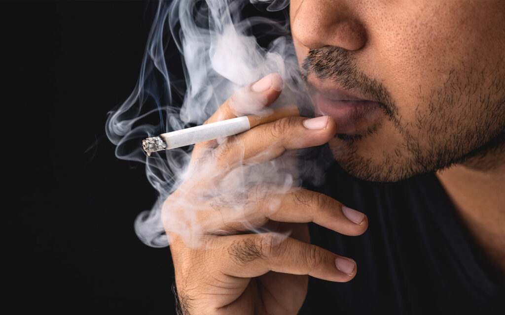 Photo of a guy smoking.