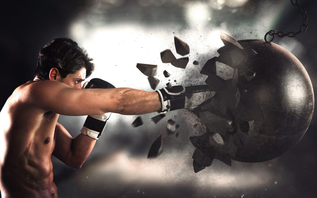 Photo of a boxer breaking apart a wrecking ball.