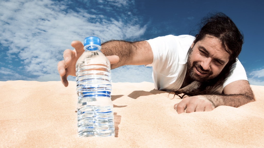 Image of a guy in a desert extending his arm to reach for the bottle of water.